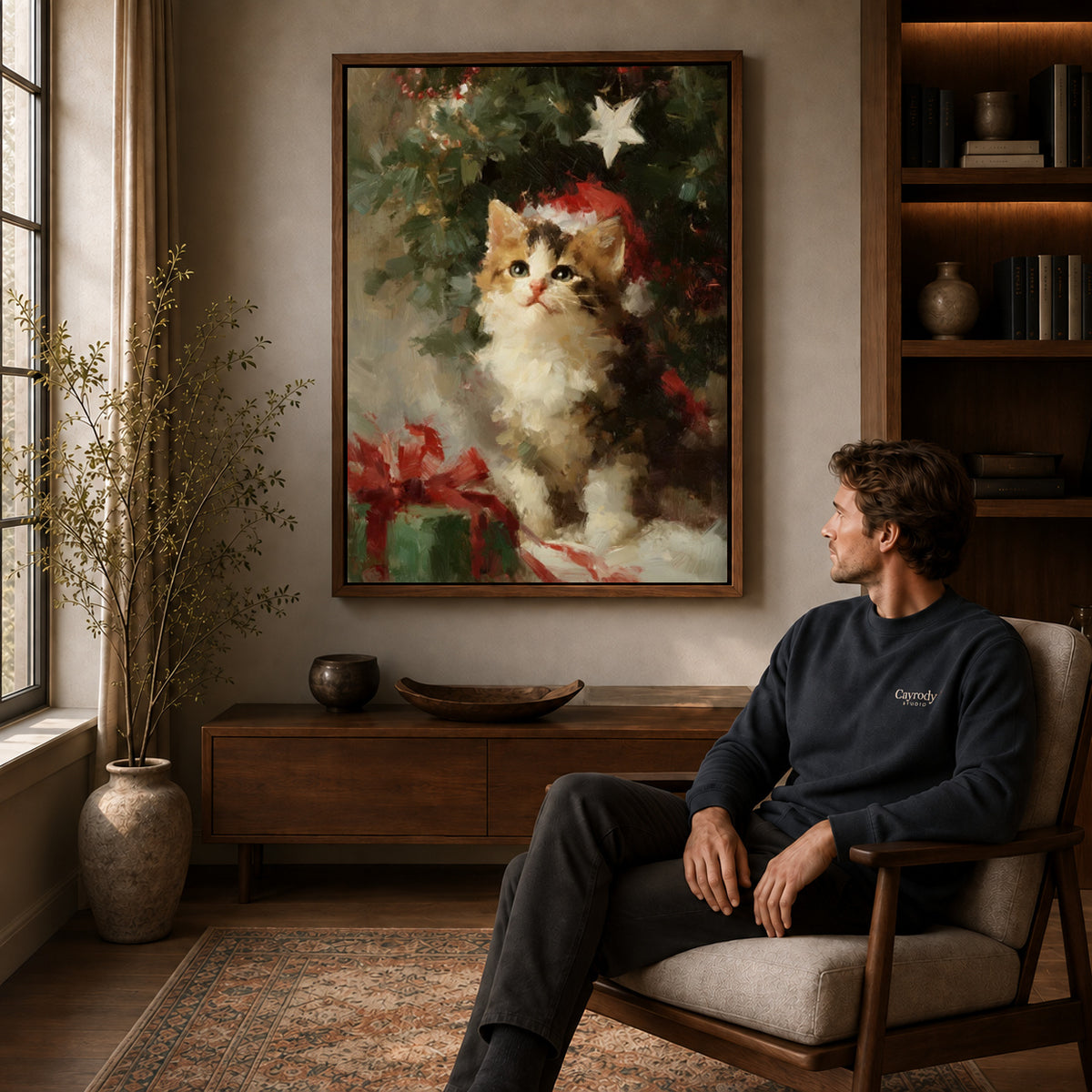 Christmas Kitten Canvas Art displayed in a walnut frame above wooden furniture beside a seated man.
