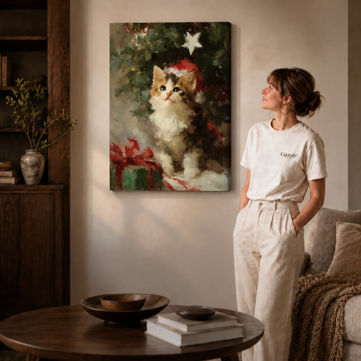 Christmas Kitten Canvas Art on gallery wrapped canvas with visible depth beside a woman in white.