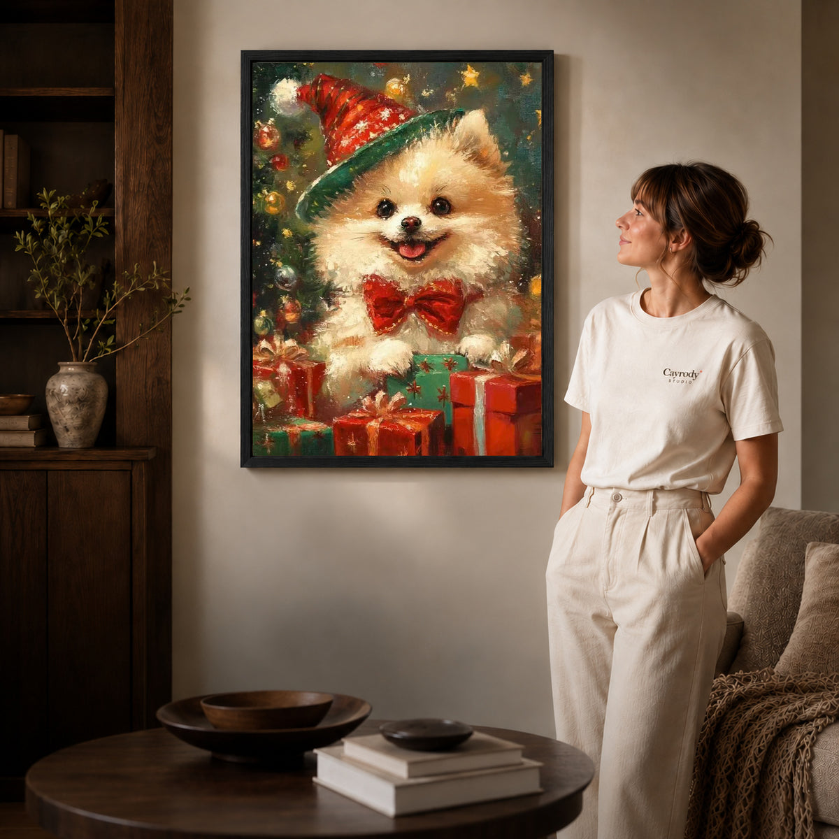 Black framed festive pomeranian canvas art displayed beside a woman with natural light across the wall.