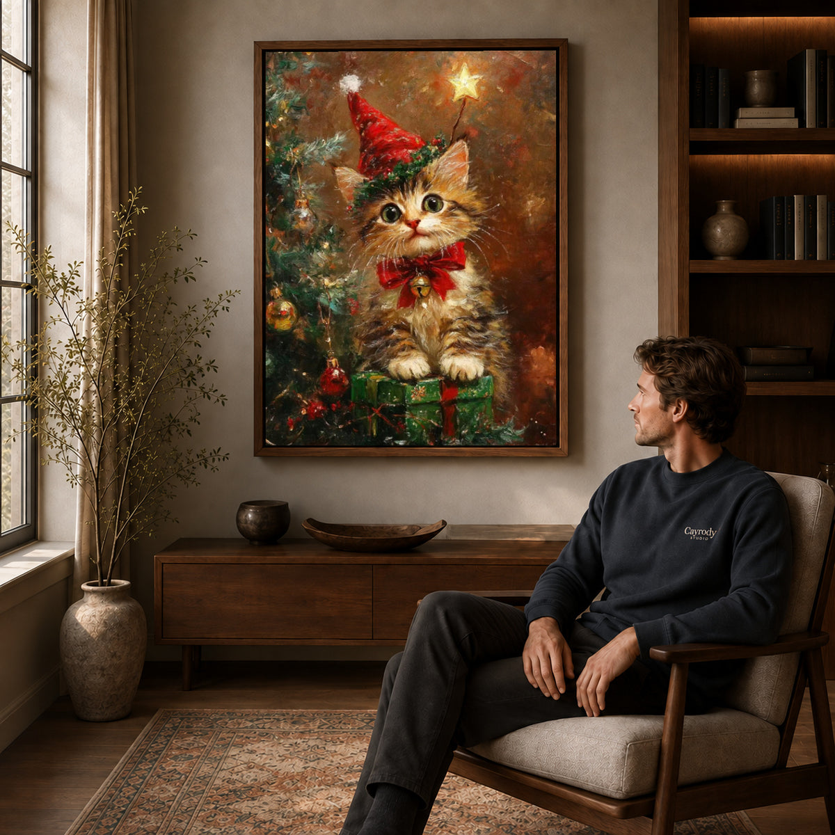 Festive Kitten Canvas Art displayed in a walnut frame above wooden furniture beside a seated man.