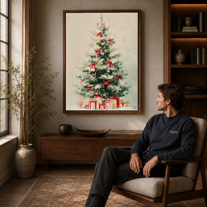 Snowy Christmas Tree Canvas Art displayed in a walnut frame above wooden furniture beside a seated man.