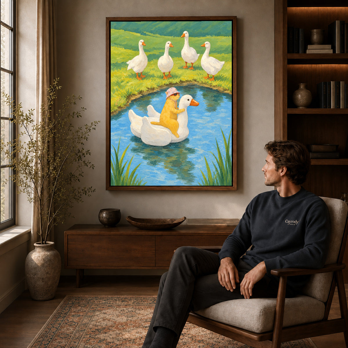 Walnut framed whimsical cat canvas art above a seated man in a cozy living room.