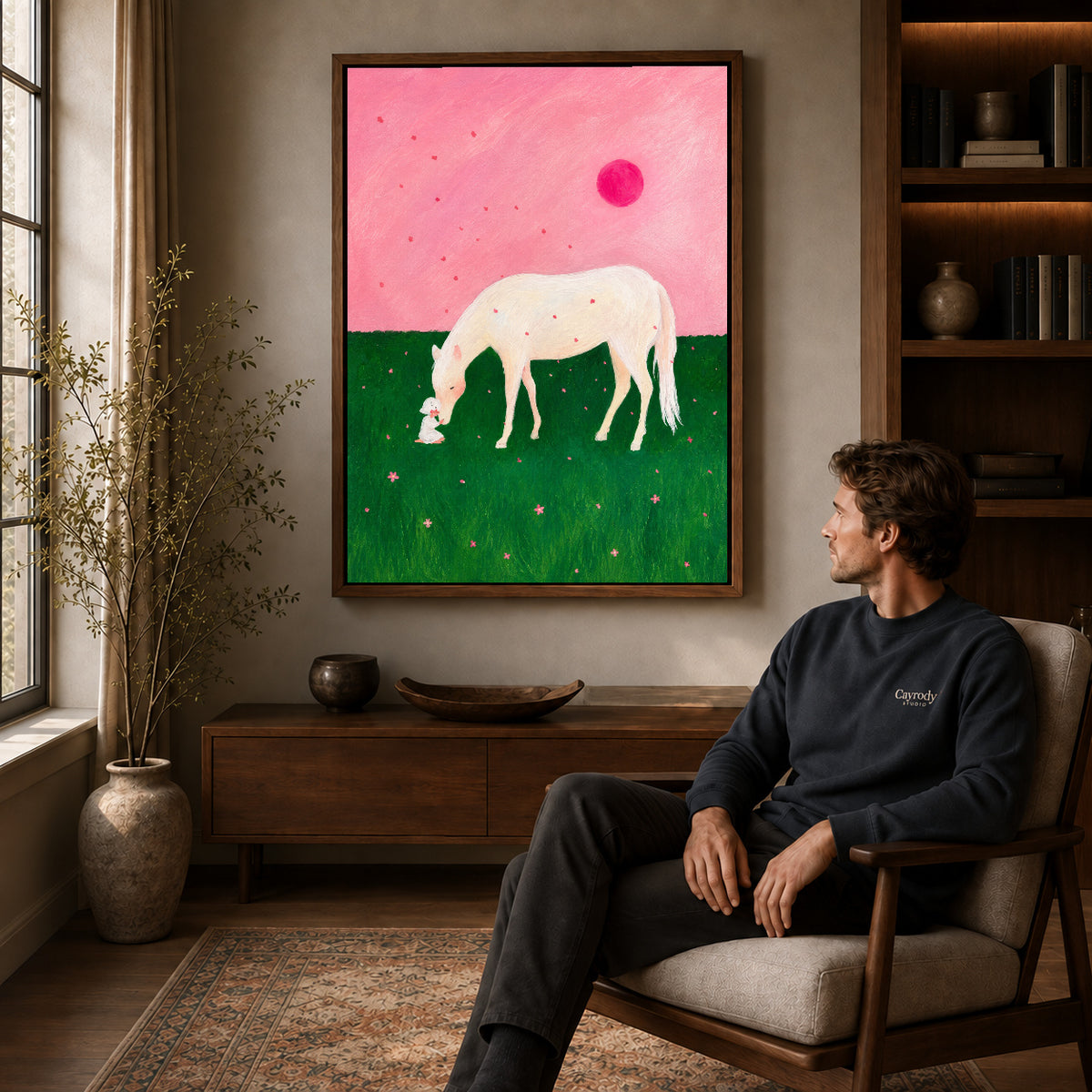 Walnut framed pink meadow horse canvas art above a seated man in a cozy wood furnished living room.