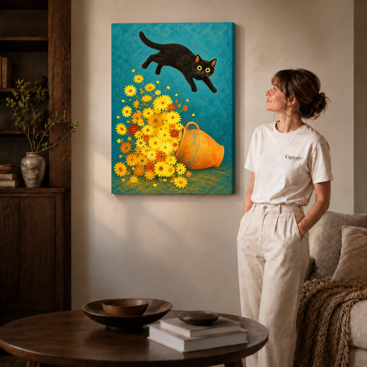 Gallery wrapped playful cat daisy canvas art with subtly shaded canvas edges beside a woman wearing cream clothing.