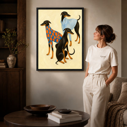 Black framed stylish greyhound trio canvas art displayed beside a woman in a warm wood living room.