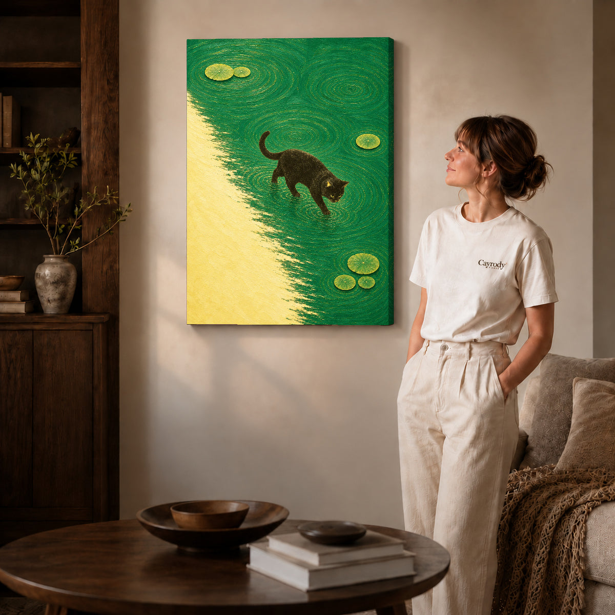 Gallery wrapped water walking cat canvas art with subtly shaded canvas edges beside a woman wearing cream clothing.