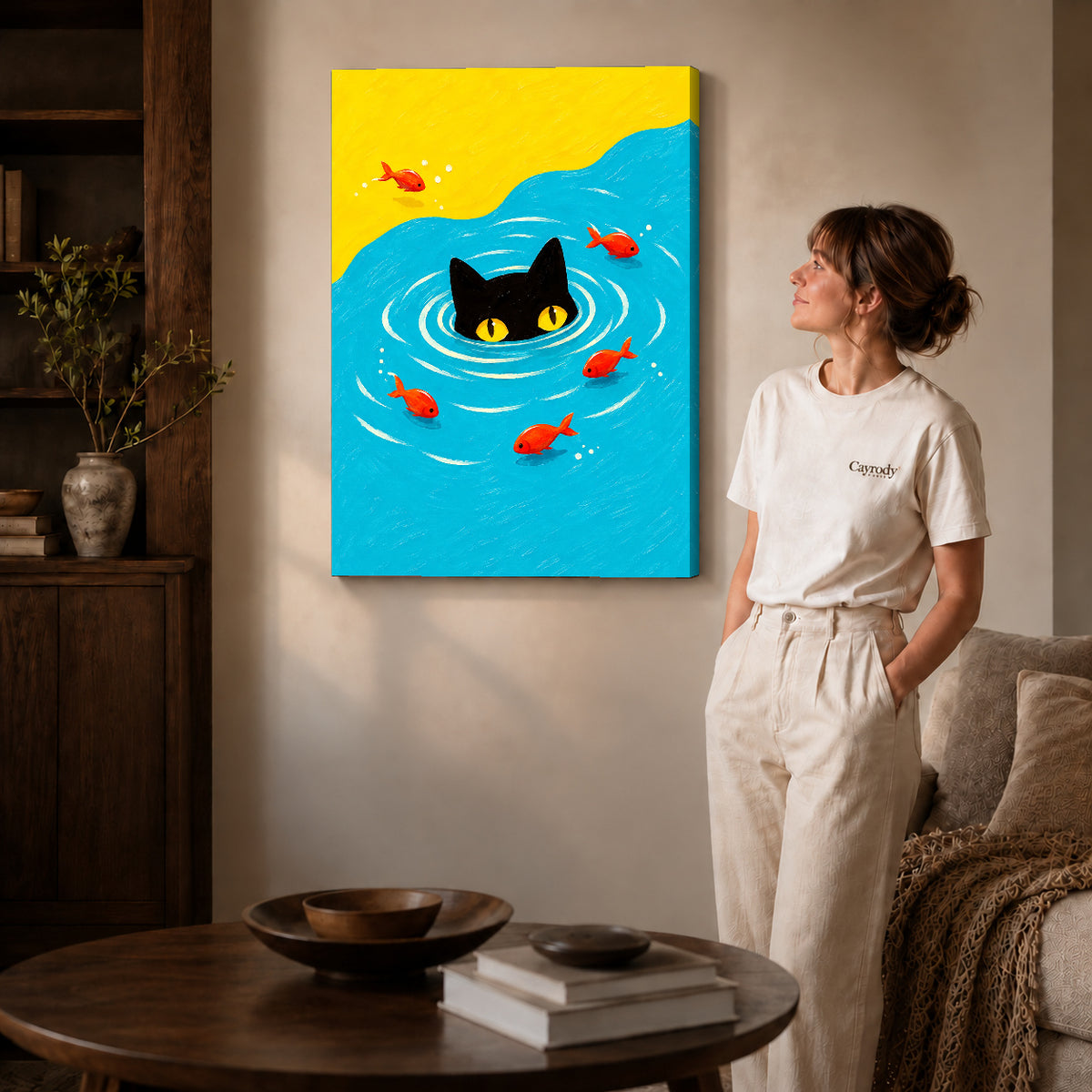 Gallery wrapped swimming black cat canvas art with subtly shaded canvas edges beside a woman wearing cream clothing.
