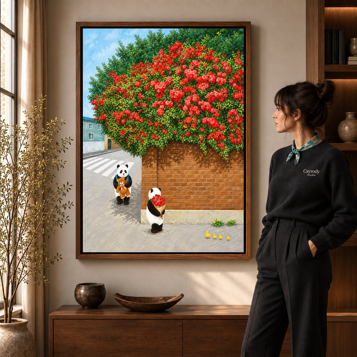 Panda rose bouquet canvas art in a walnut frame beside a woman in a warm living room.