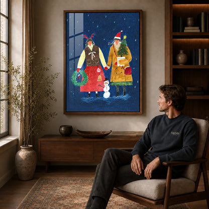 Folk Christmas canvas art in a walnut frame above a console beside a seated man.