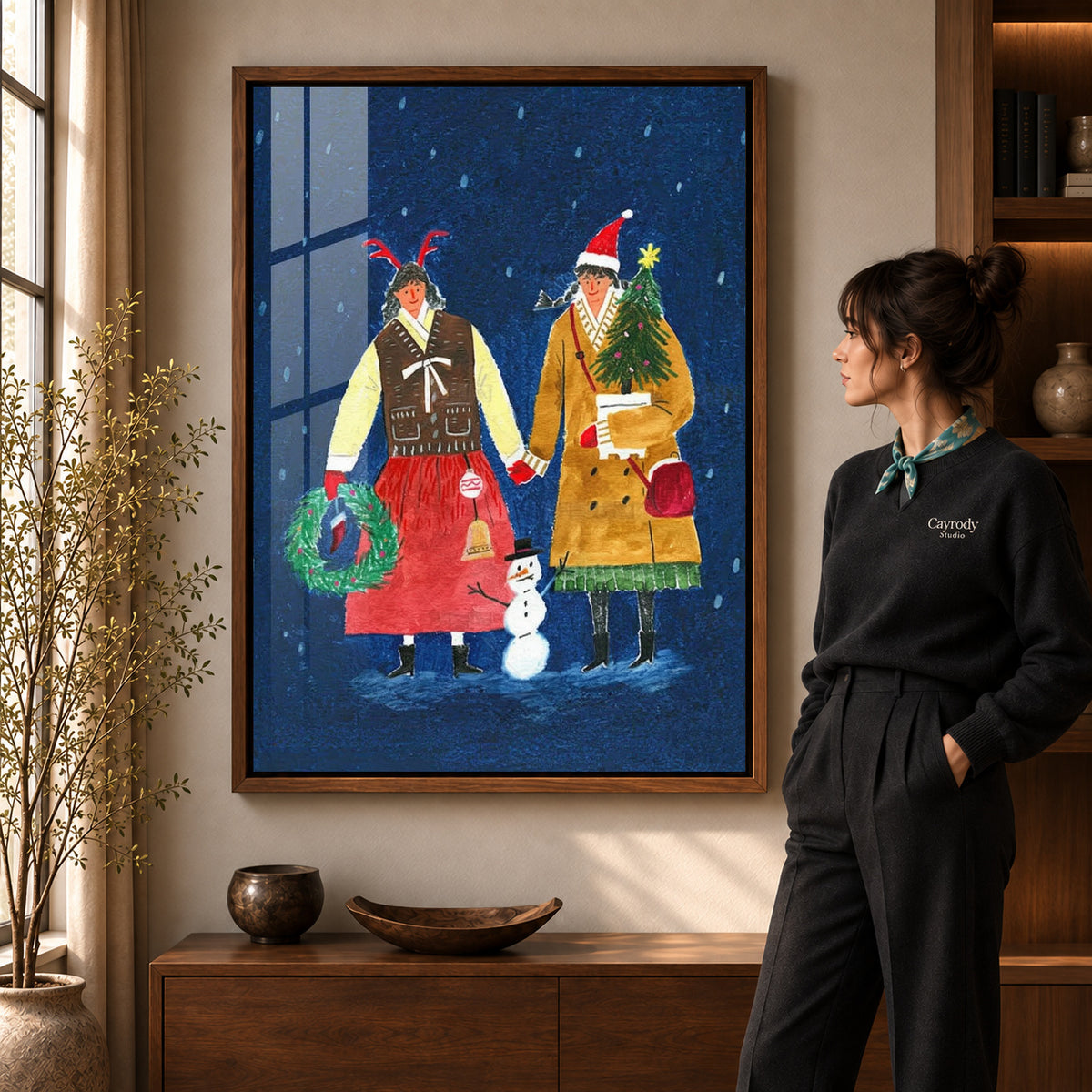 Folk Christmas canvas art shown in the walnut frame option within a warm living room.