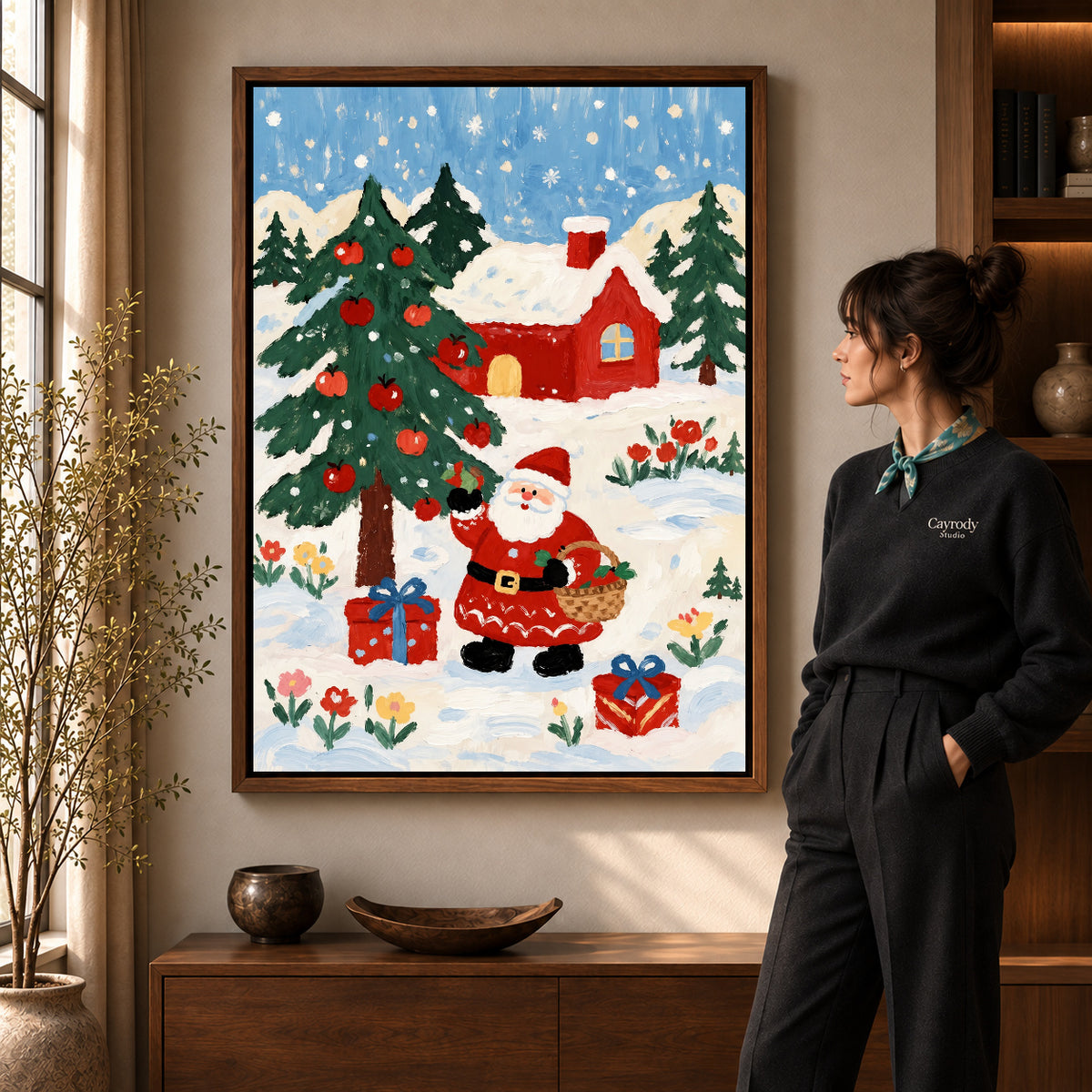 Folk Santa canvas art in a walnut frame beside a standing woman and wooden console.