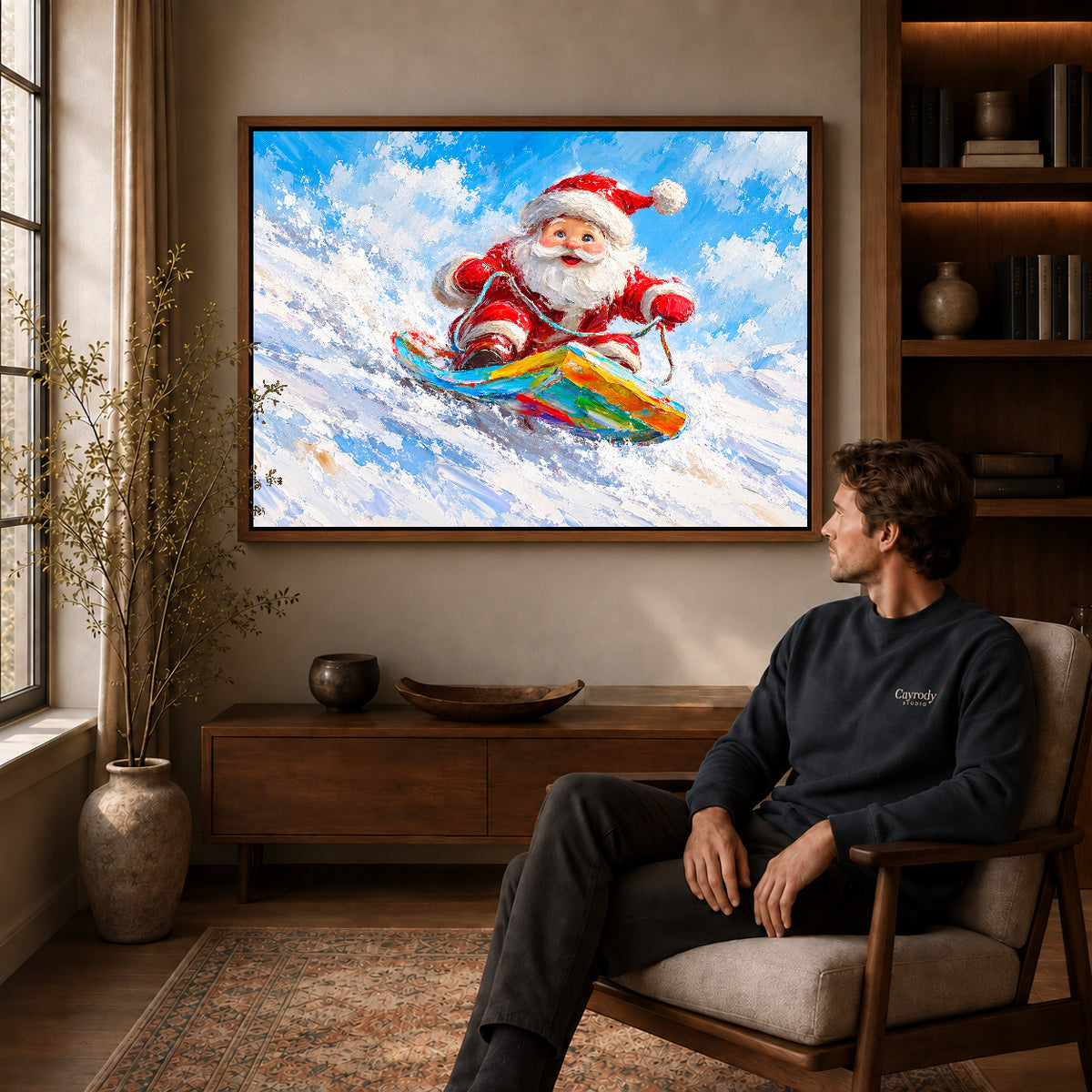 Snowboard Santa canvas art in a walnut frame above a console beside a seated man.