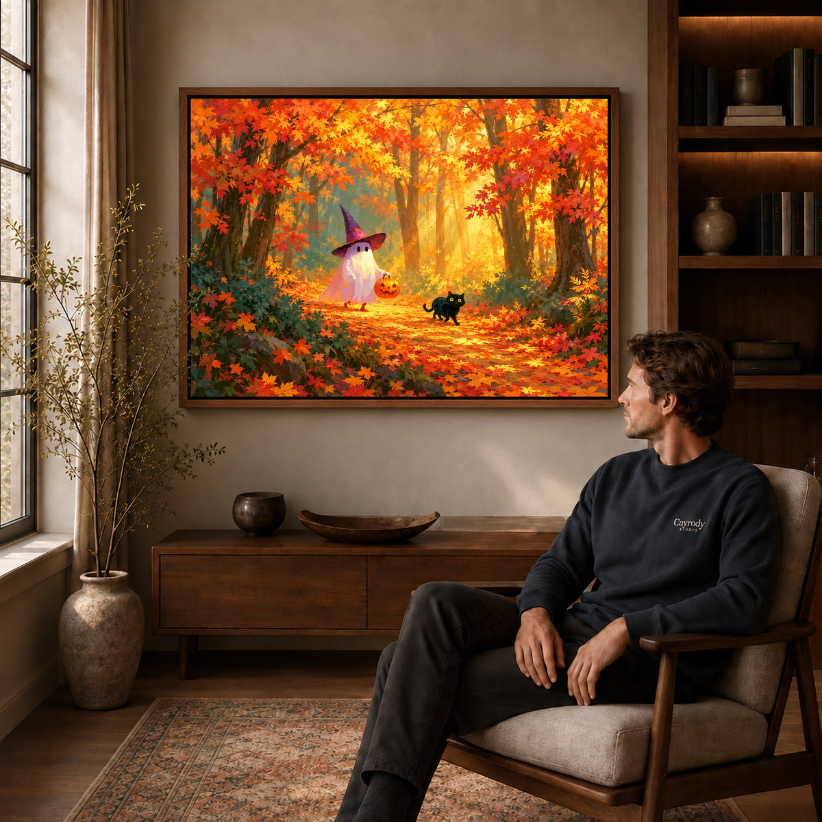 Autumn ghost canvas art in a walnut frame above a console beside a seated man.