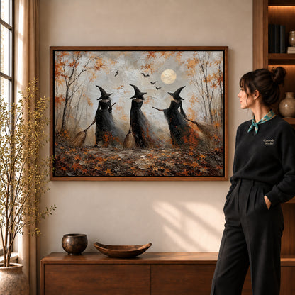 Woodland witches canvas art in a walnut frame beside a standing woman and wooden console.