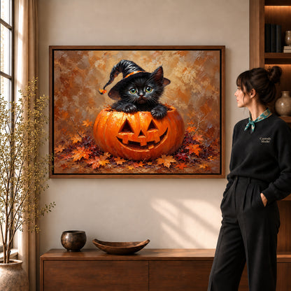 Pumpkin kitten canvas art in a walnut frame beside a standing woman and wooden console.