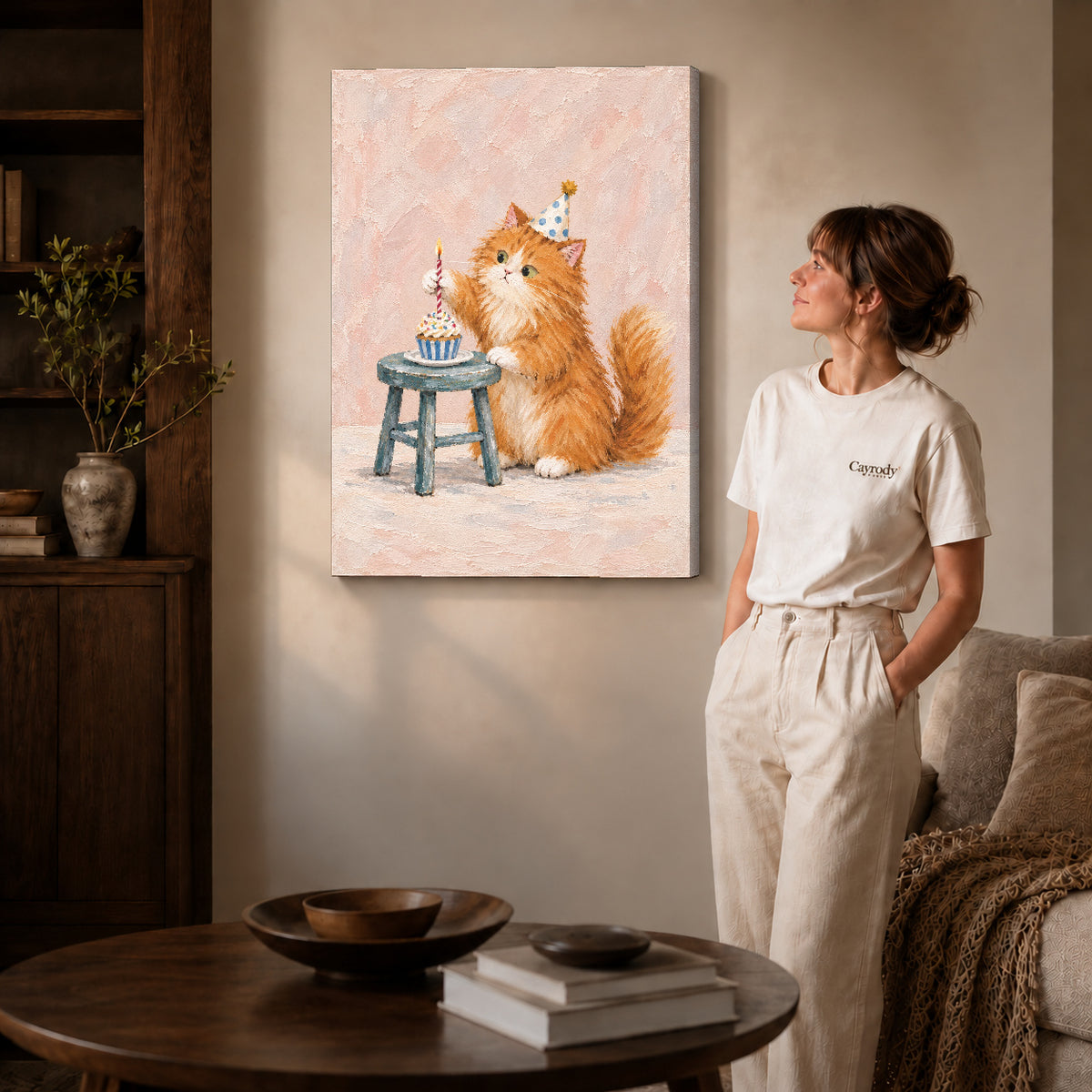 Birthday kitten canvas art on gallery-wrapped canvas with natural edge shading beside a standing woman.