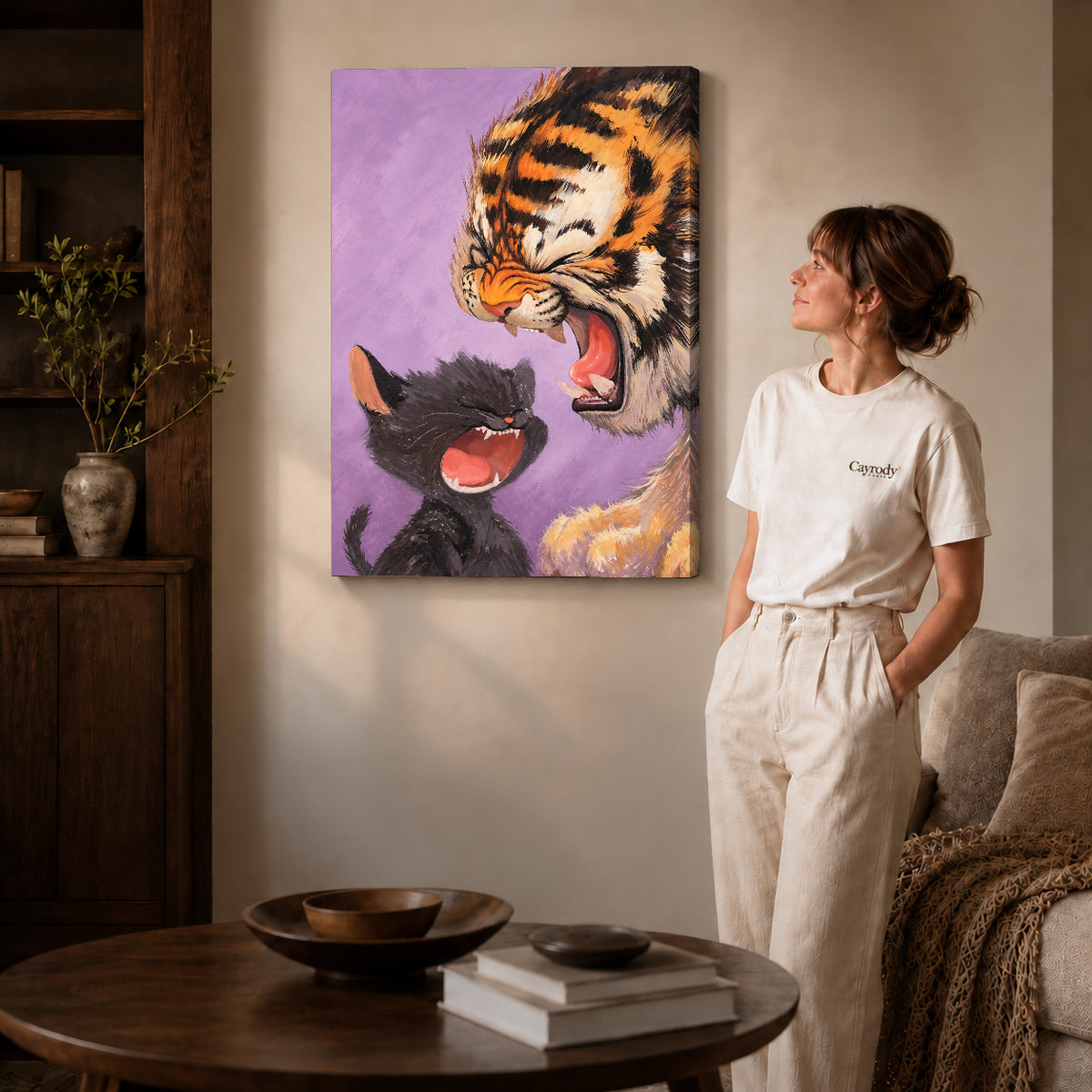 Laughing Tiger Kitten canvas art on gallery-wrapped canvas with natural edge shading beside a standing woman.