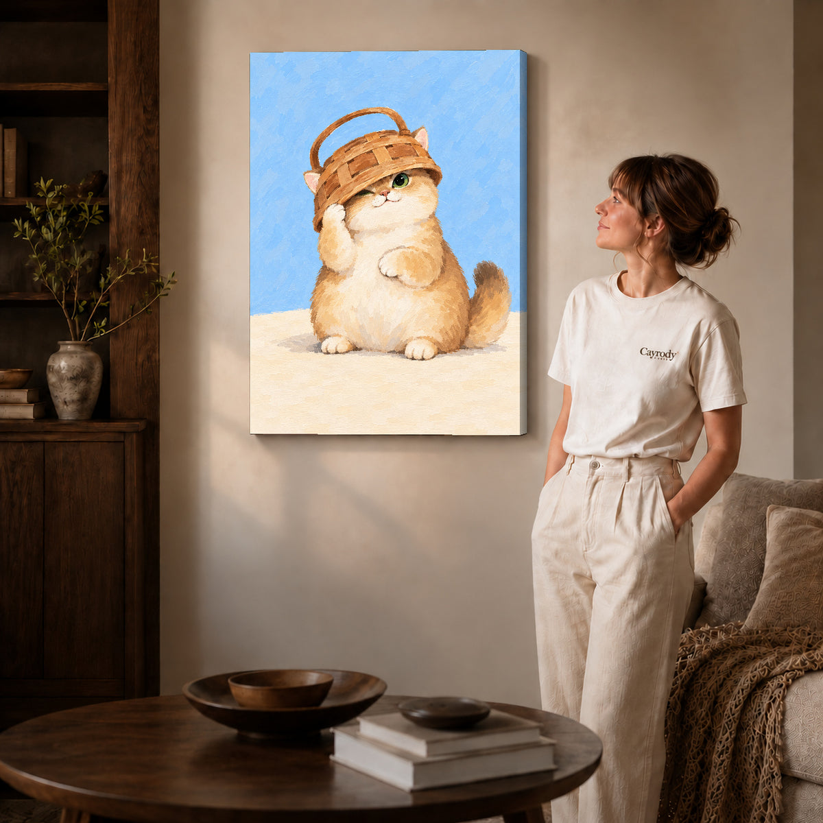 Basket kitten canvas art on gallery-wrapped canvas with natural edge shading beside a standing woman.