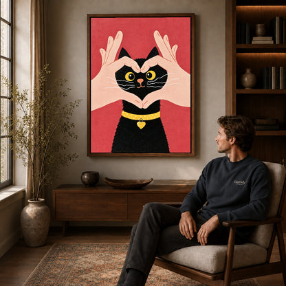 Heart kitten canvas art in a walnut frame above a console beside a seated man.