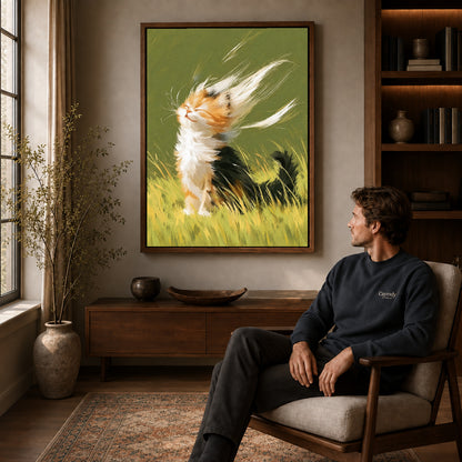 Calico kitten canvas art in a walnut frame above a console beside a seated man.