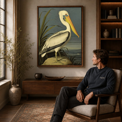 Vintage pelican canvas art in a walnut frame above a console beside a seated man.