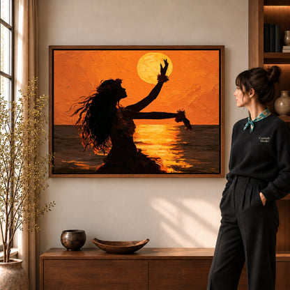 Sunset dancer canvas art in a walnut frame beside a standing woman and wooden console.