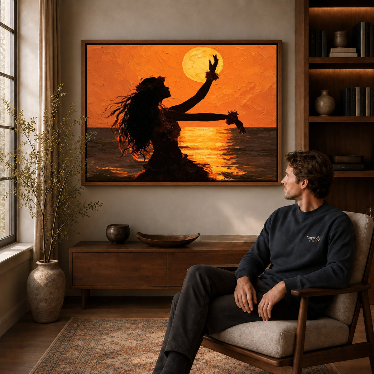 Sunset dancer canvas art in a walnut frame above a console beside a seated man.