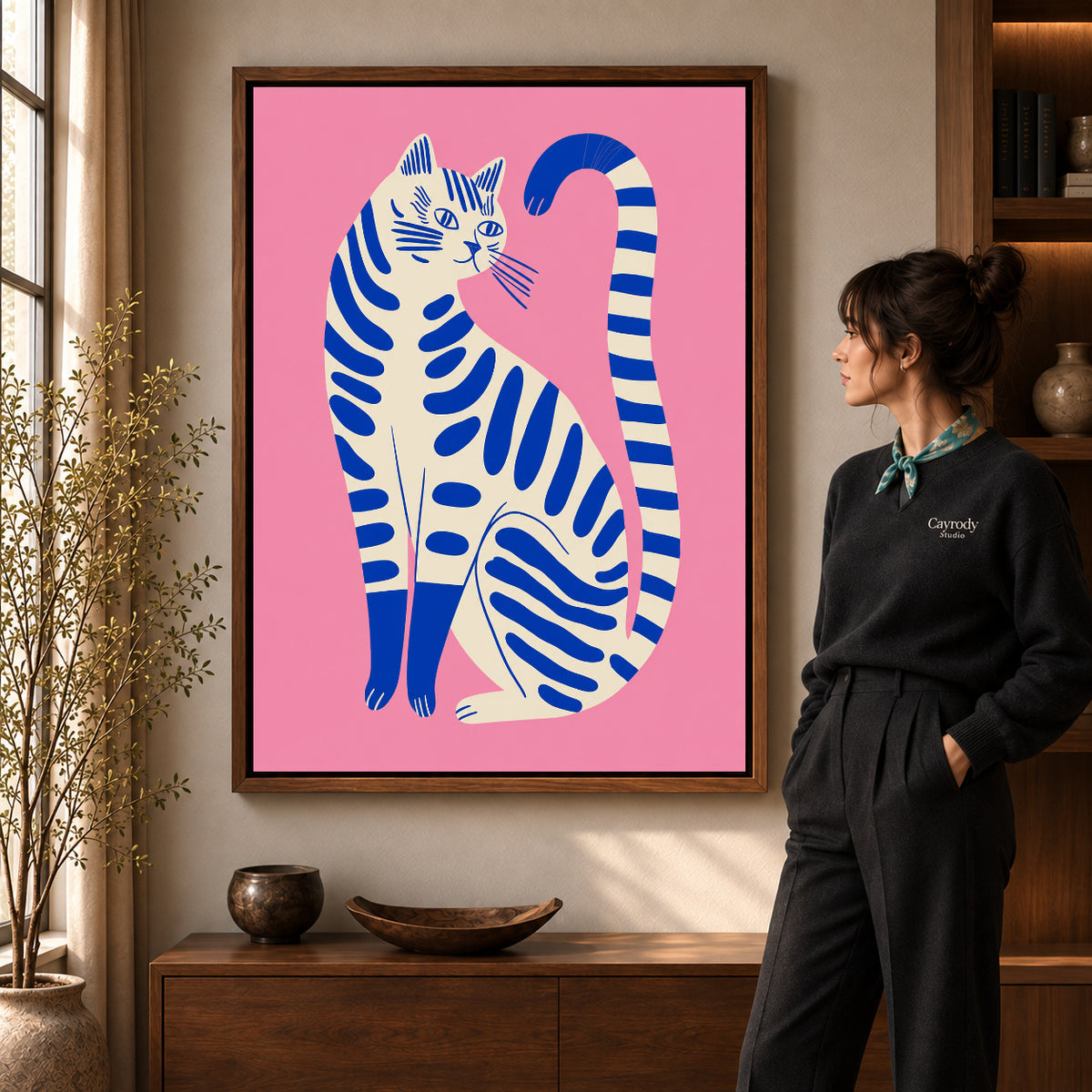Striped cat canvas art shown in the walnut frame option within a warm living room.