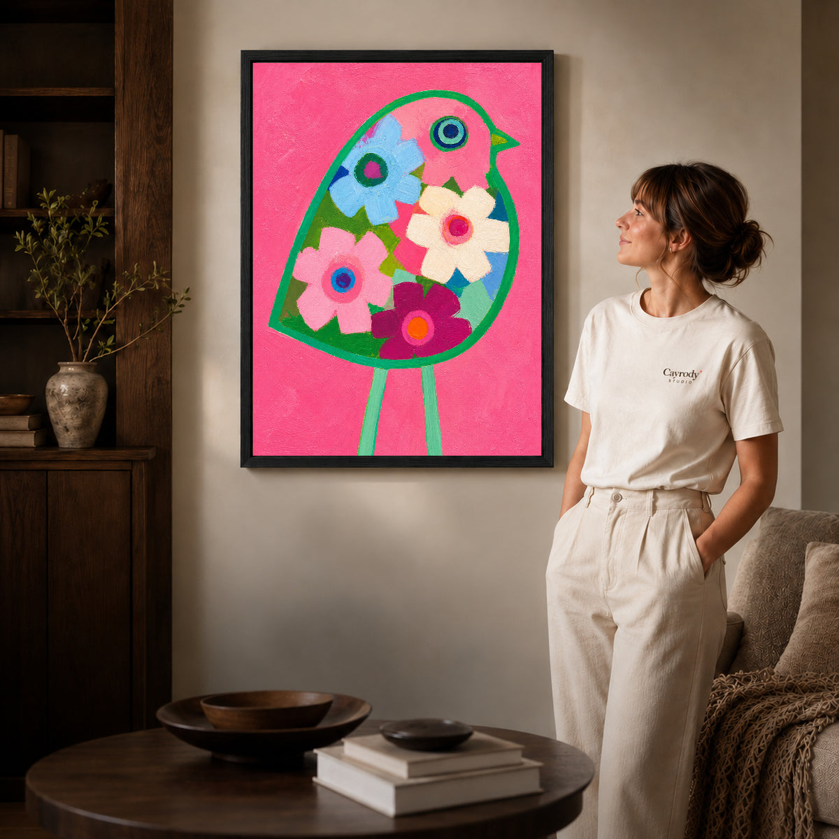 Floral bird canvas art shown in the black frame option against a softly lit wall.