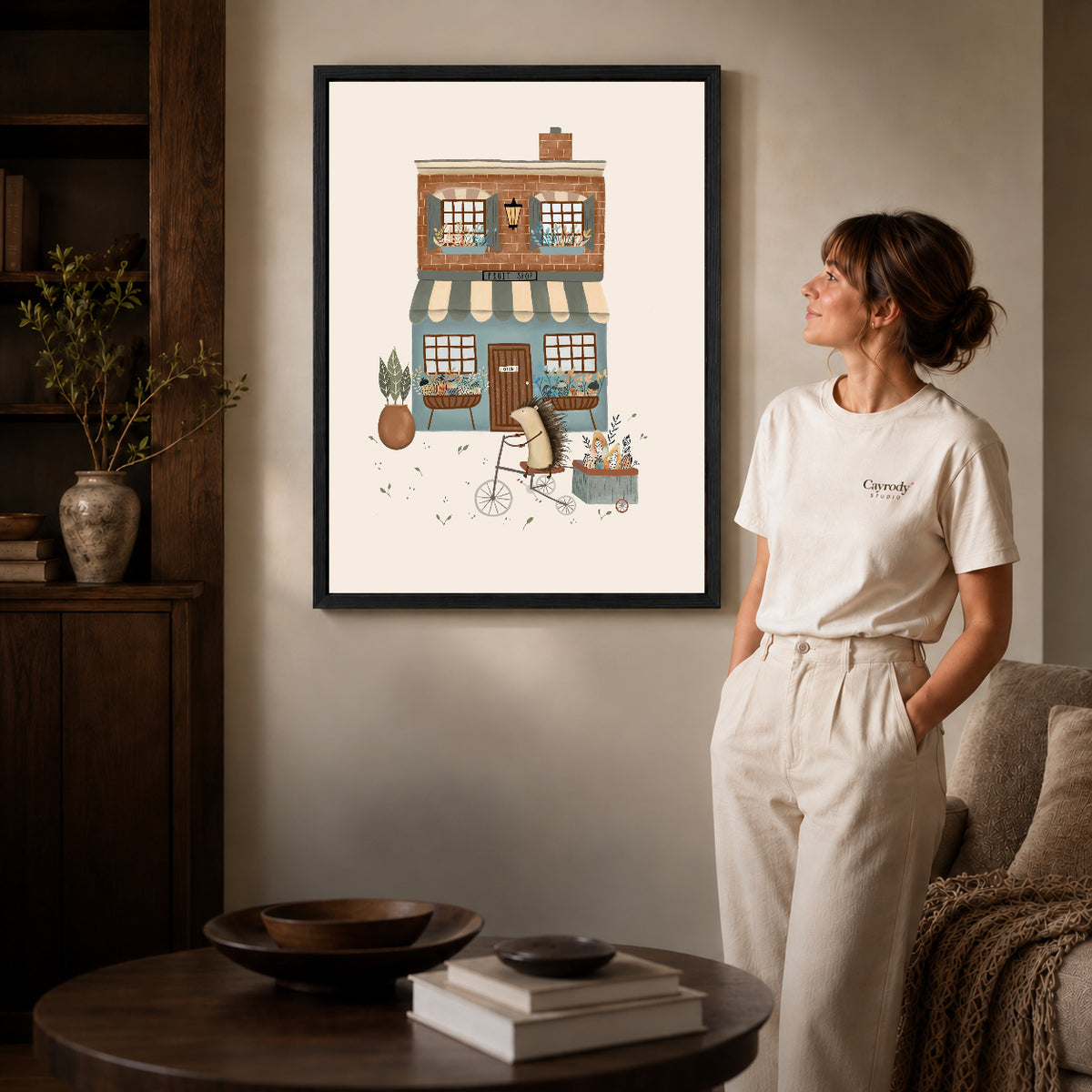 Hedgehog fruit shop canvas art shown in the black frame option against a softly lit wall.