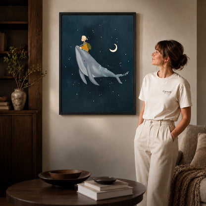 Whale rider canvas art in a black frame beside a woman and round wooden table.