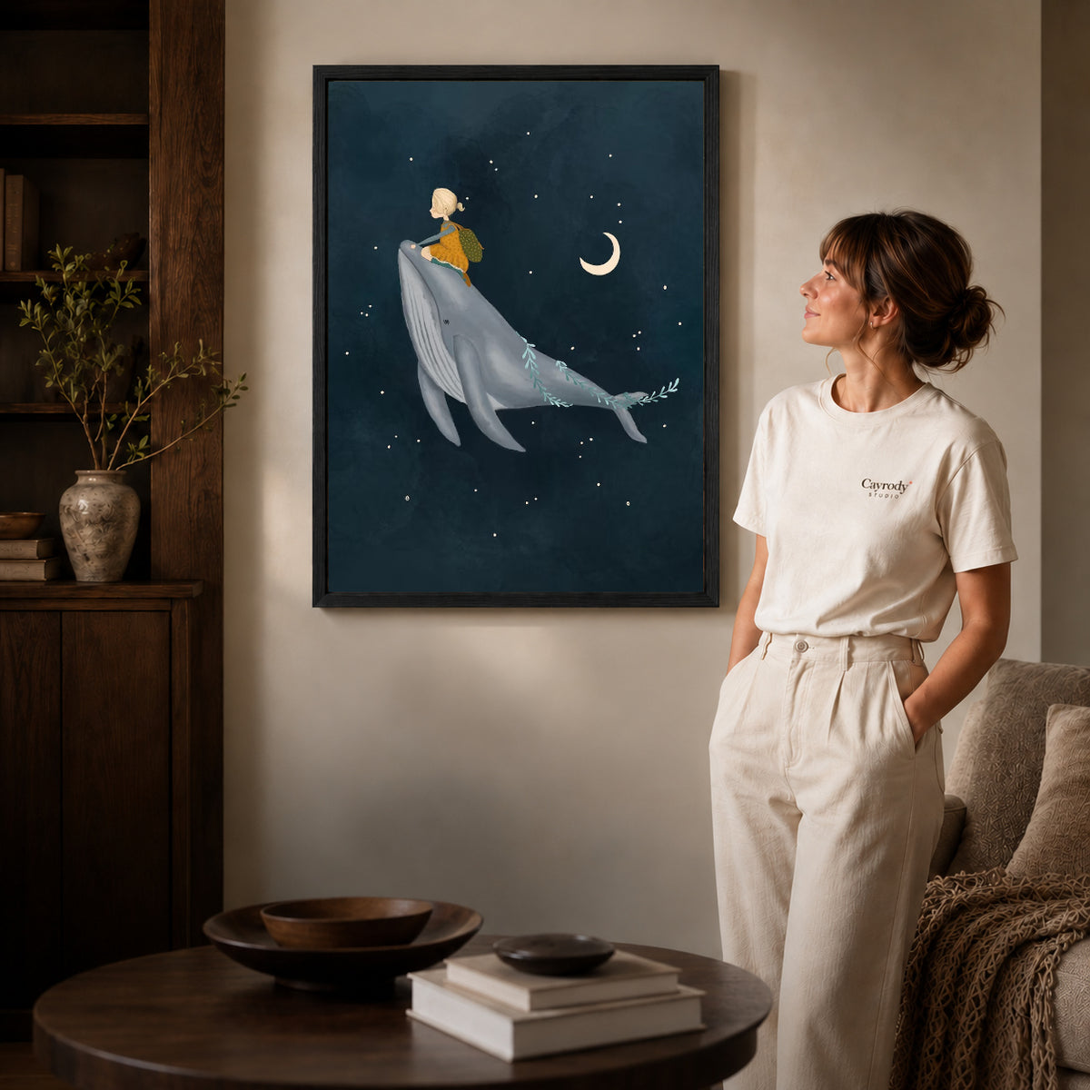 Whale rider canvas art shown in the black frame option against a softly lit wall.
