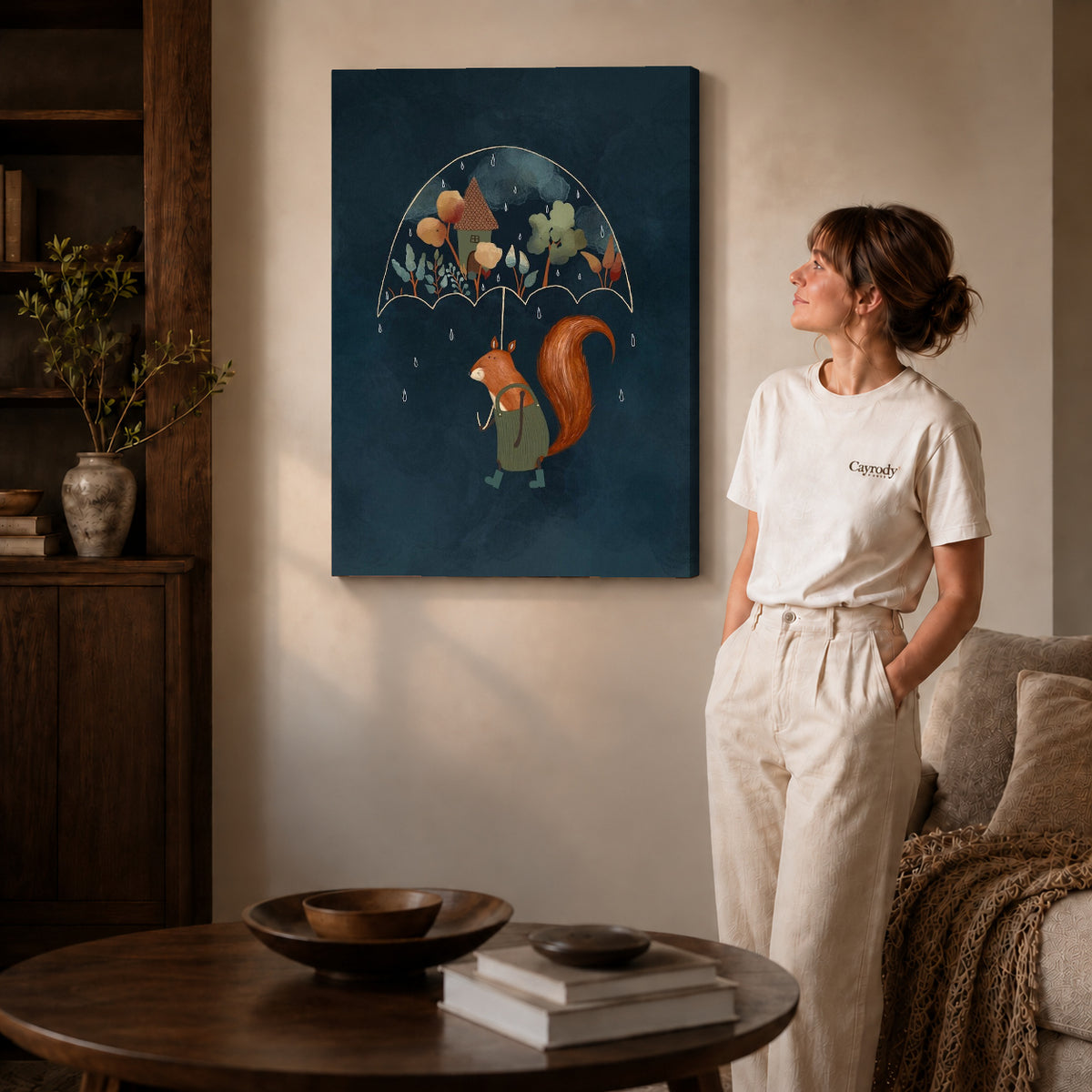 Squirrel umbrella canvas art on gallery-wrapped canvas with natural edge shading beside a standing woman.
