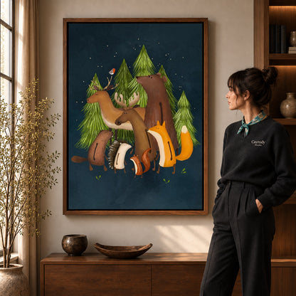 Woodland friends canvas art in a walnut frame beside a standing woman and wooden console.