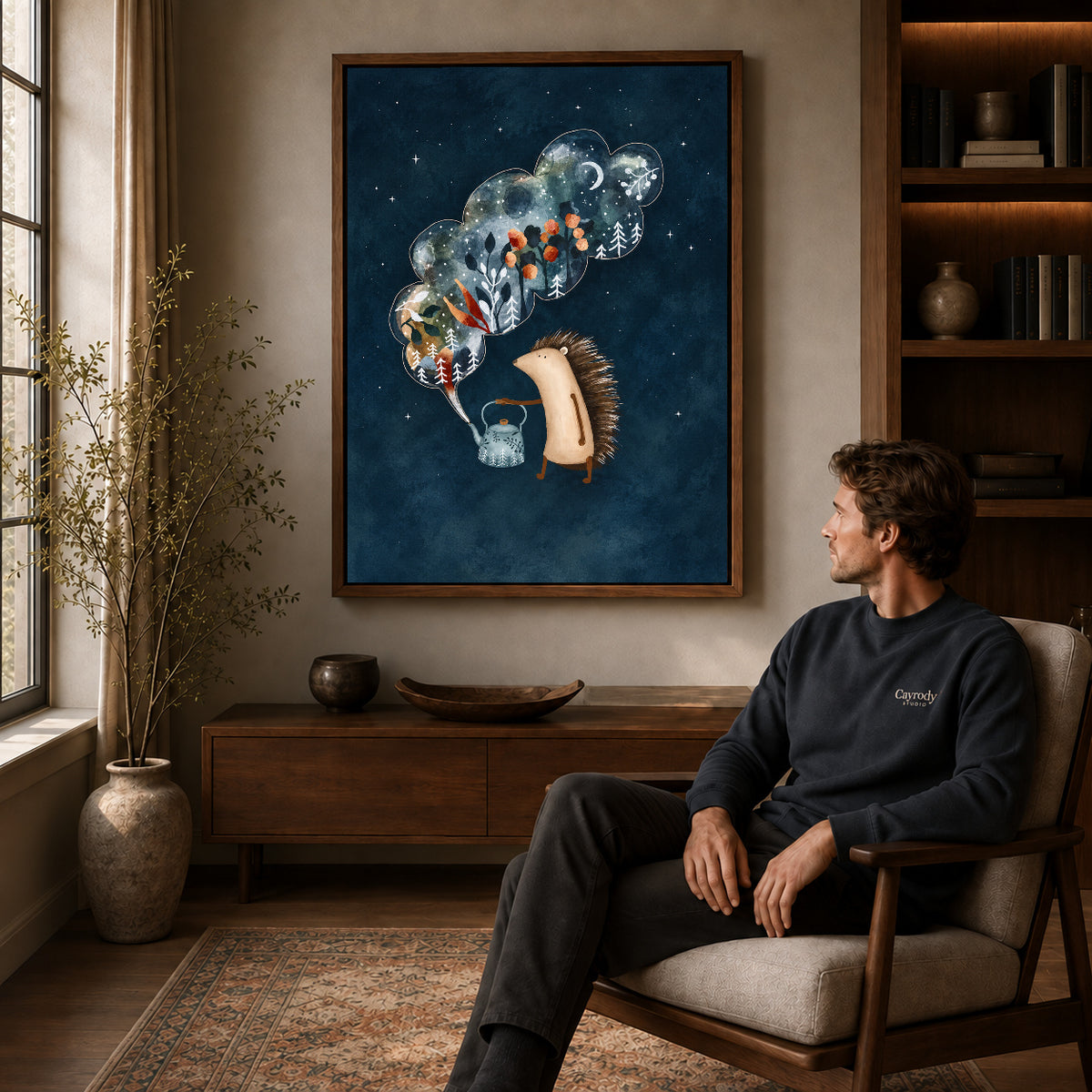 Hedgehog canvas art in a walnut frame above a console beside a seated man.