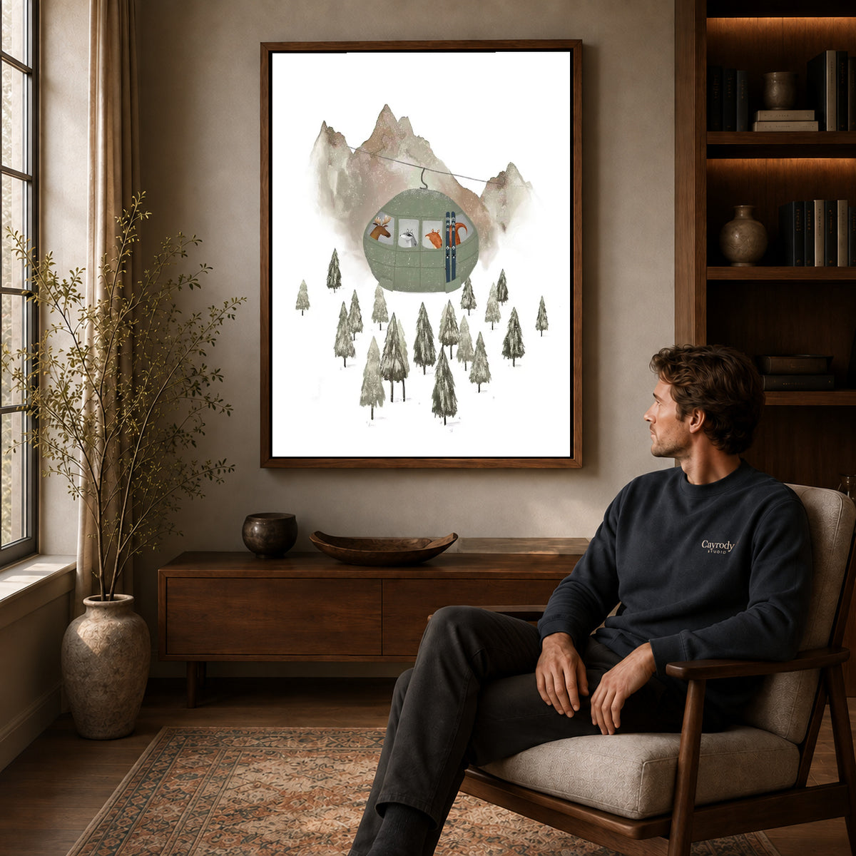Ski gondola canvas art in a walnut frame above a console beside a seated man.