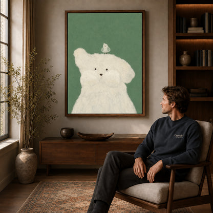 Puppy and bird canvas art in a walnut frame above a console beside a seated man.