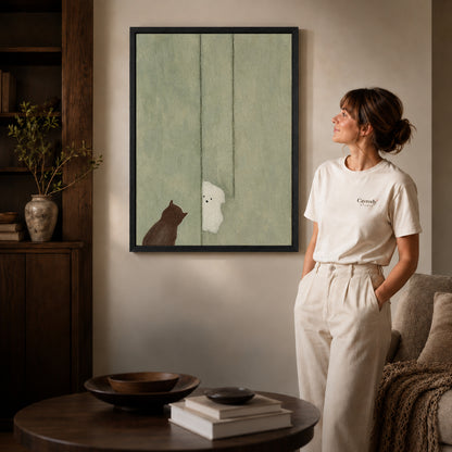 Ghost cat canvas art shown in the black frame option with warm furnishings and a standing woman.