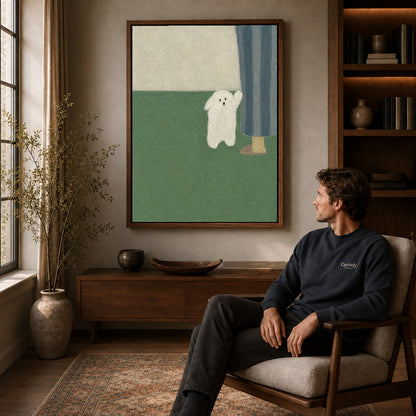 Little ghost canvas art in a walnut frame above a console beside a seated man.