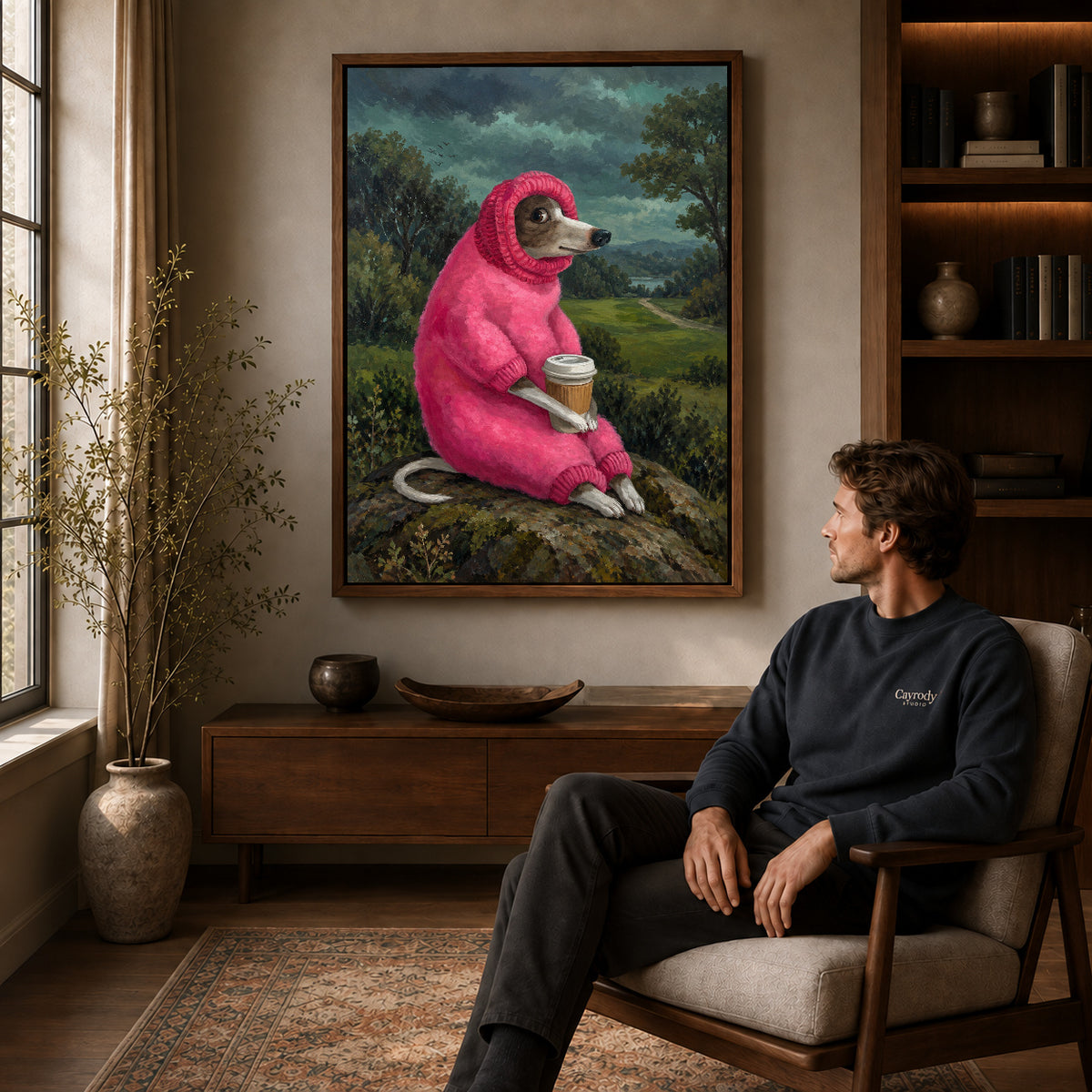 Coffee dog canvas art in a walnut frame above a console beside a seated man.