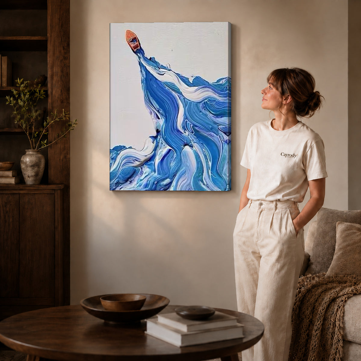 Blue wave canvas art on gallery-wrapped canvas with natural edge shading beside a standing woman.