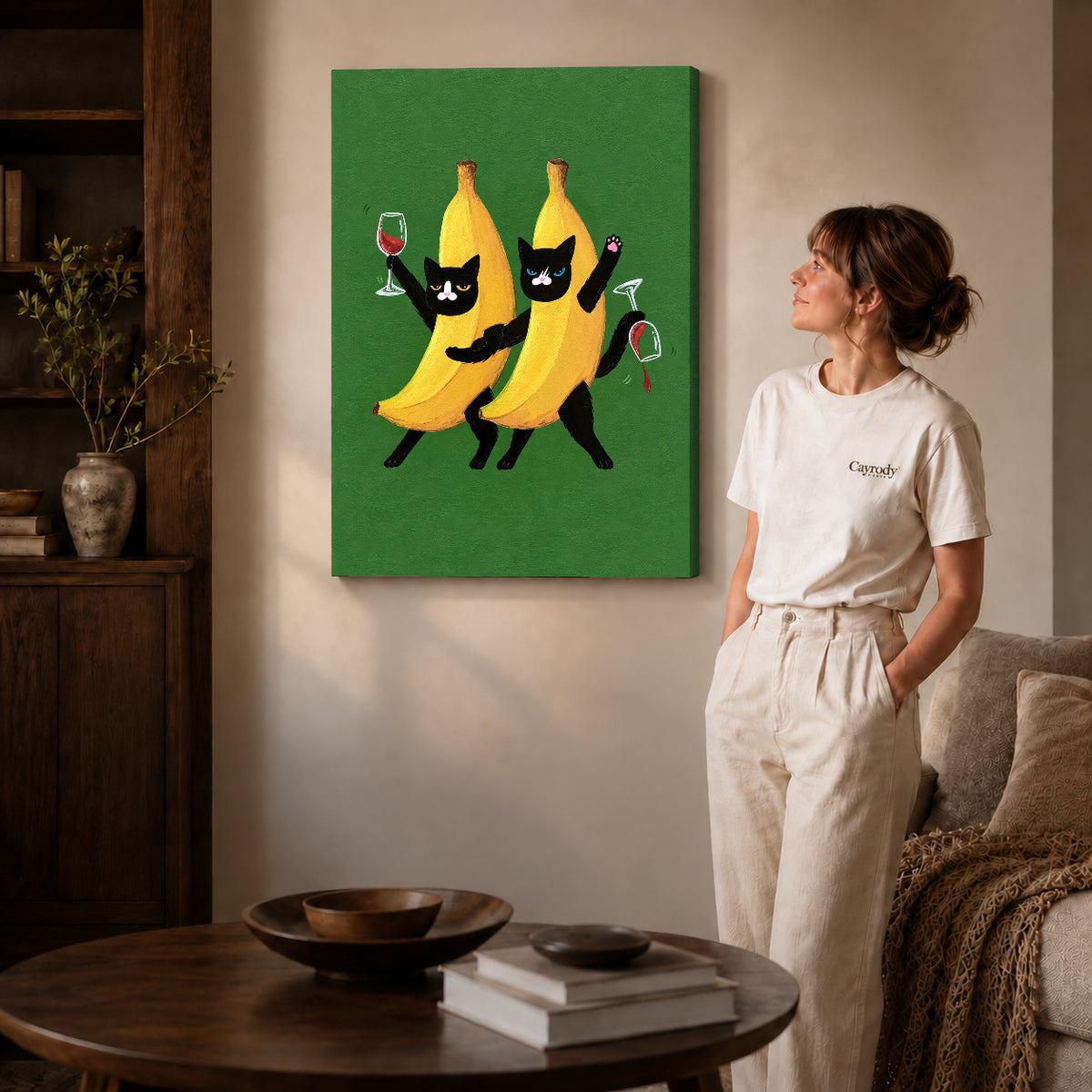 Banana cats canvas art on gallery-wrapped canvas with natural edge shading beside a standing woman.