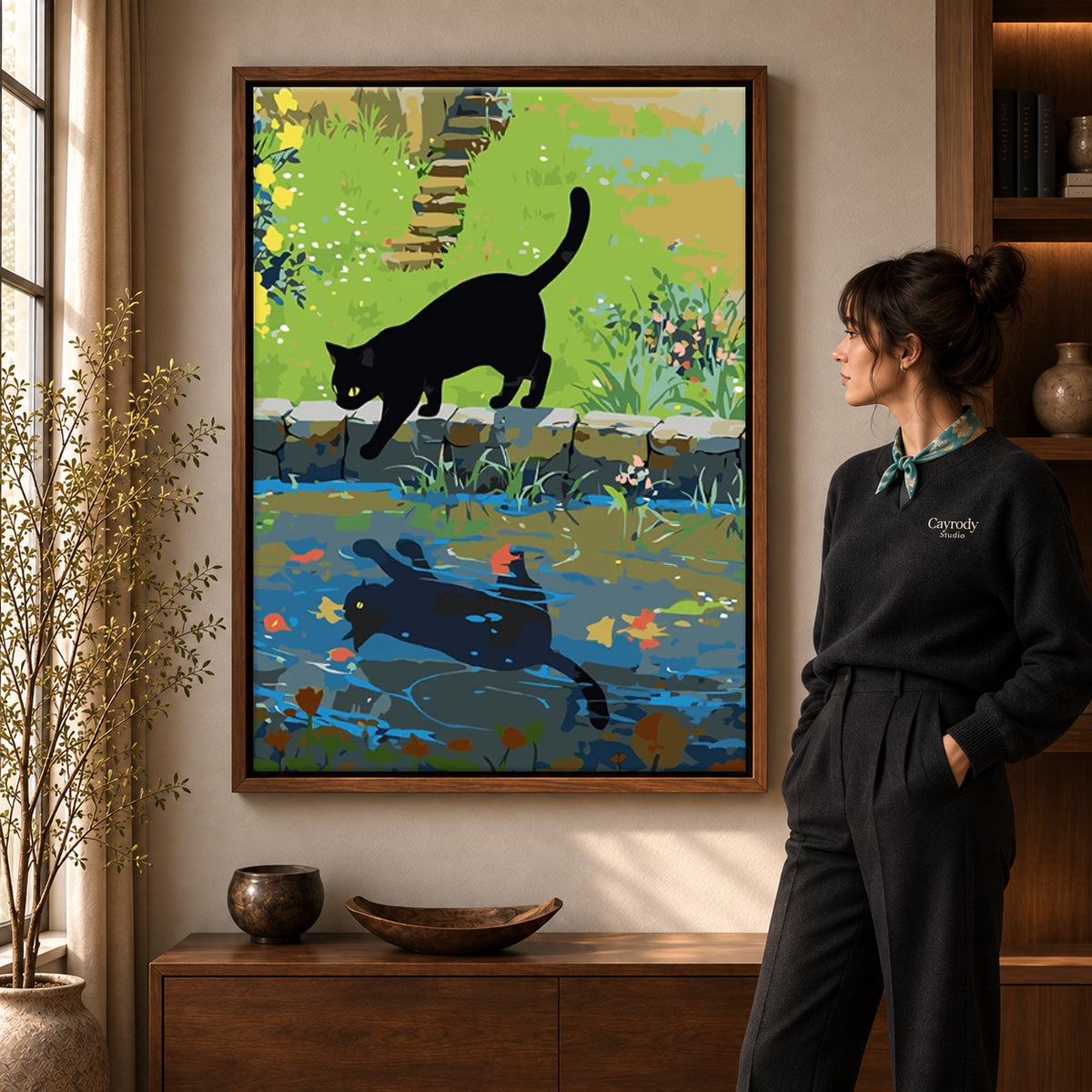 Black cat canvas art shown in the walnut frame option within a warm living room.