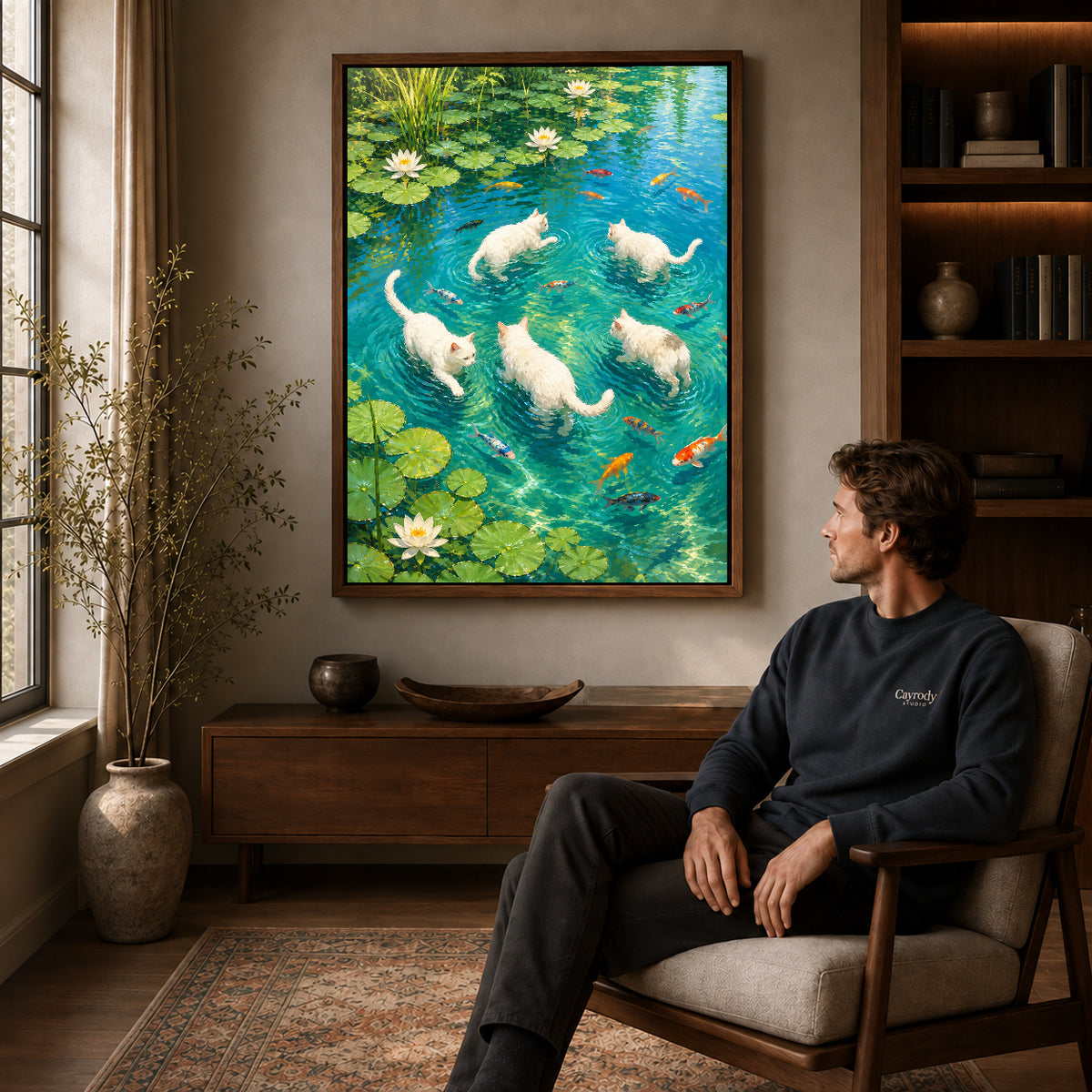 Cats lily pond canvas art in a walnut frame above a console beside a seated man.