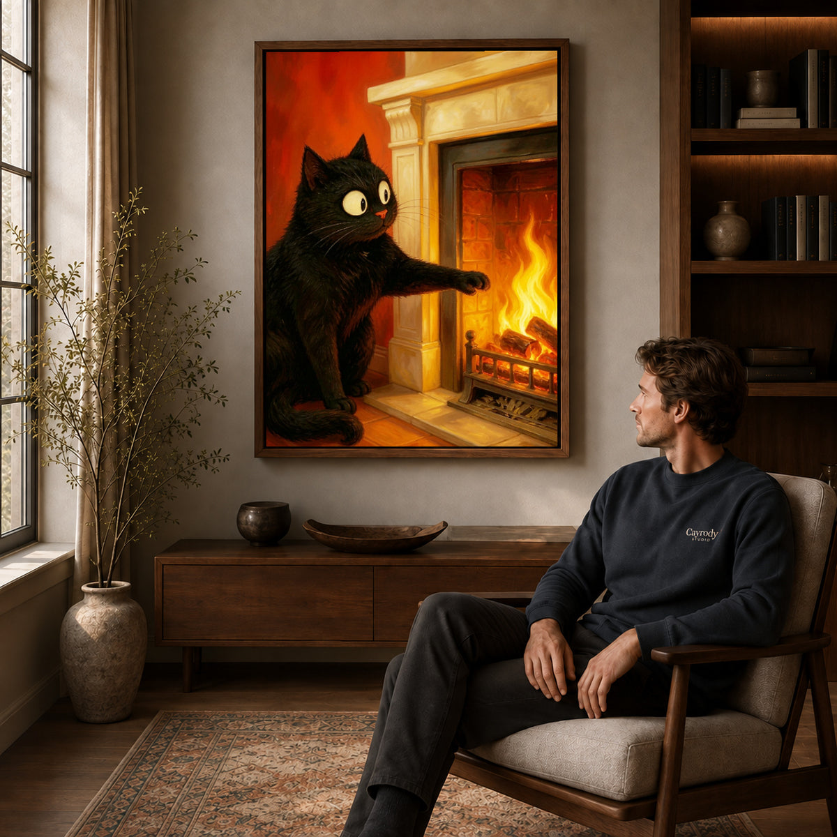 Fireplace cat canvas art in a walnut frame above a console beside a seated man.