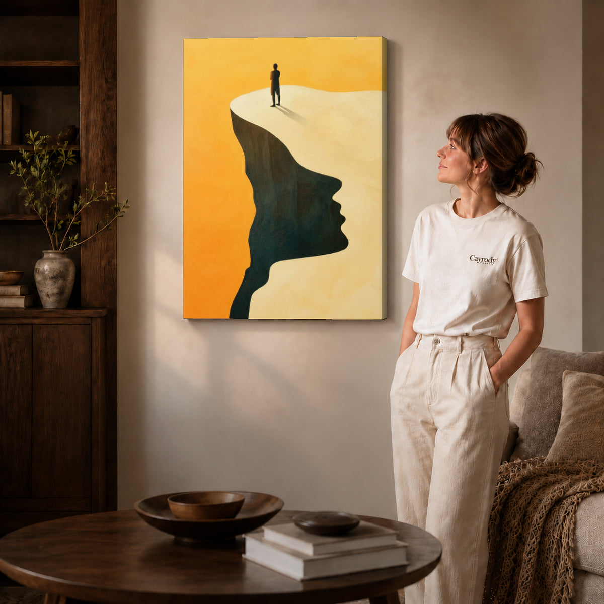 Surreal landscape canvas art on gallery-wrapped canvas with natural edge shading beside a standing woman.