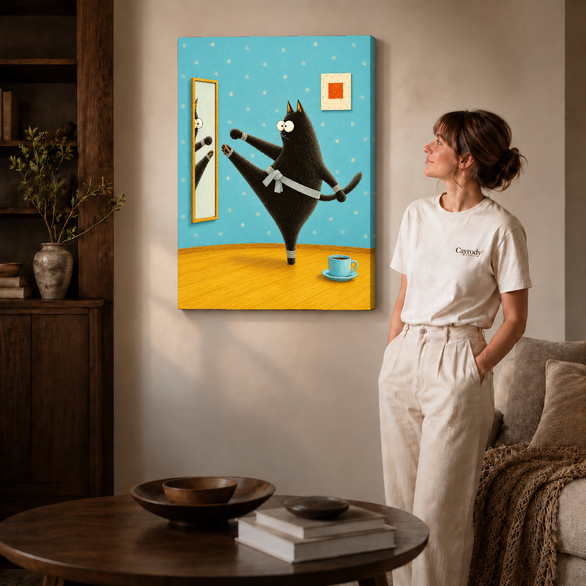 whimsical karate cat canvas art on gallery-wrapped canvas with natural edge shading beside a standing woman.