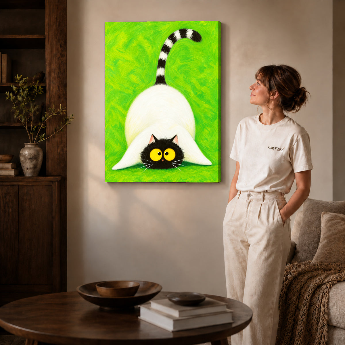 Playful cat canvas art on gallery-wrapped canvas with natural edge shading beside a standing woman.