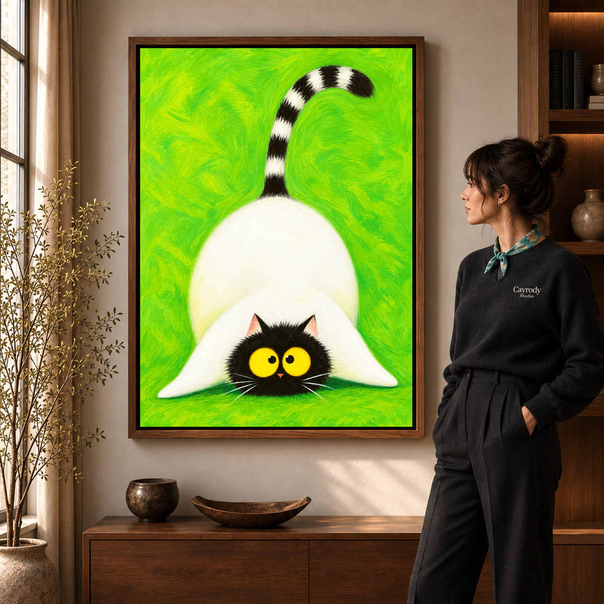 Playful cat canvas art shown in the walnut frame option within a warm living room.