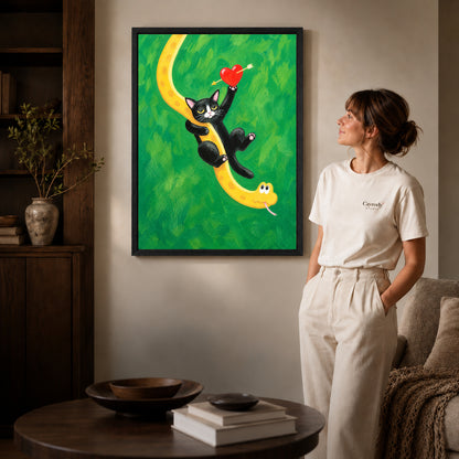 Cat and snake canvas art in a black frame beside a woman and round wooden table.